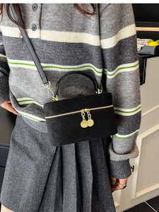 Chic black quilted crossbody box bag with gold zippers and top handle for women