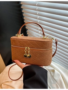 Brown quilted suede box bag with gold hardware and adjustable crossbody strap