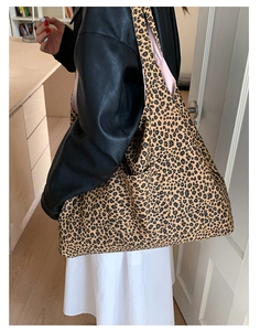 Leopard print canvas tote bag featuring a spacious design and a convenient side pocket