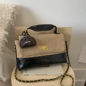 Detail of vintage crossbody bag with khaki suede, black quilted leather and gold chain