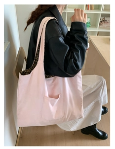 Detail of pink canvas tote bag showing leopard print lining and wide shoulder strap