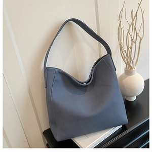 Close-up of the grey-blue large tote bag with magnetic clasp and wide strap