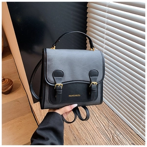 Detailed view of vintage two-tone backpack with leather texture and buckle closure