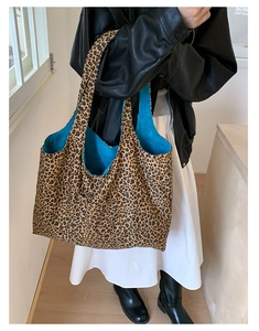 Detailed shot of leopard print tote bag with striking royal blue lining on shoulder
