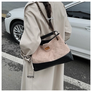 Detail of vintage large capacity tote bag with khaki suede and black leather stitching