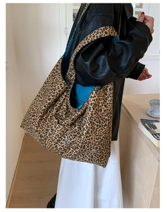 Detail view of large leopard print tote bag with striking bright blue interior lining