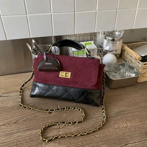 Detail of vintage patchwork crossbody bag with burgundy suede and black quilted leather