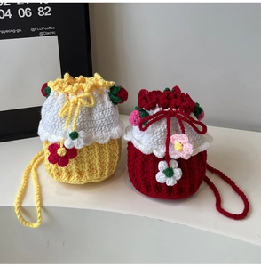 Detail of handcrafted crochet bucket bags with 3D floral accents in yellow and red