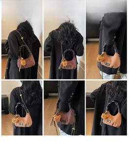 Retro half-moon crossbody bag in dark brown with a plush bear charm and chain strap