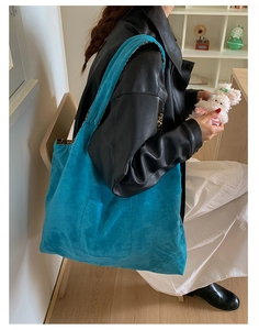 Detail of blue faux suede tote bag with leopard print lining and front patch pocket