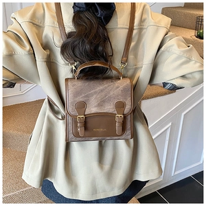 Retro brown contrast color backpack shown worn as a stylish crossbody bag for women
