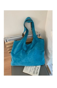 Detail of blue corduroy tote bag featuring leopard print lining and front pocket
