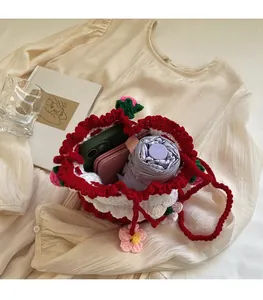Detail showing the internal storage capacity of the handmade crochet strawberry bucket bag