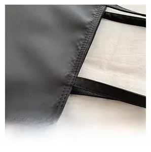 Close-up of double stitching detail on black canvas tote bag for premium craftsmanship