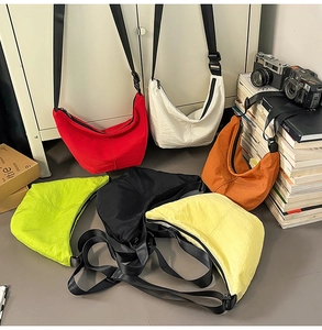 Detailed view of colorful nylon crescent crossbody bags in various vibrant colors