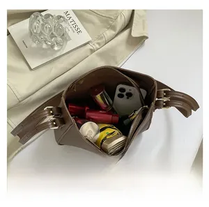 Top view showing large capacity of the brown square bag with phone, lipstick and umbrella