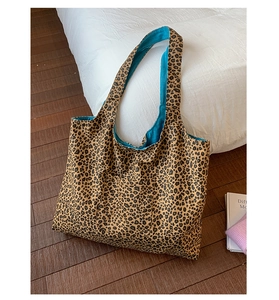 Detail view of the leopard print tote bag featuring a vibrant blue inner fabric lining