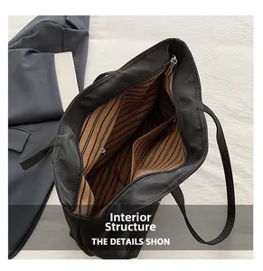Spacious tote bag interior with striped lining, zipper pocket, and dual slots