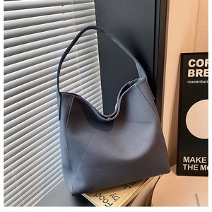 Detail of a large blue tote bag in a modern setting with natural light by a window