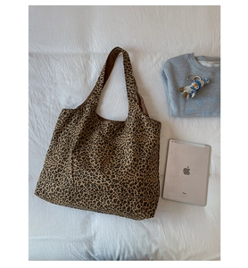 Detailed internal view of a leopard print tote bag next to an iPad for size reference
