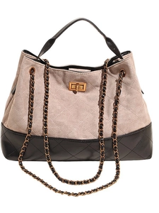 Quilted beige and black tote bag with chain strap and metallic gold turn-lock closure
