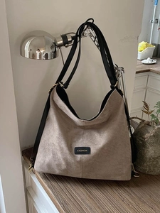 Large khaki suede tote bag with black leather shoulder straps and fashion logo patch
