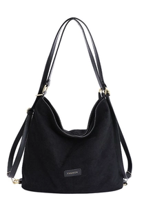 Large black minimalist backpack with 'FASHION' label and gold metal buckles for women