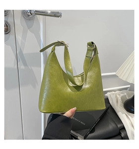 Close-up of Matcha green leather hobo bag with adjustable strap and gold hardware