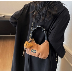 Brown suede hobo bag with ruffled handle, plush bear charm and gold chain strap