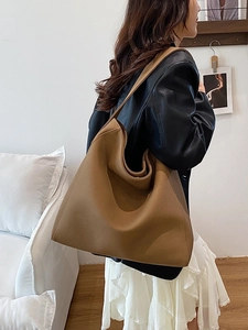 Large brown minimalist tote bag shown on a model for commute and casual styling