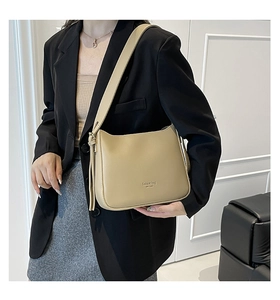 Beige Hobo bag with Fashion Bag New York lettering styled with a black blazer