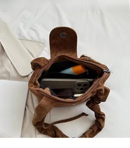 Interior view of brown suede bucket bag showing large capacity for essentials