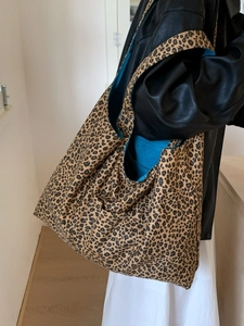 Retro leopard print tote bag with blue lining shown on shoulder for daily styling