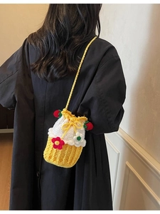 Handmade crochet bucket bag with strawberry and floral details in yellow and white colors
