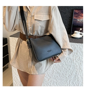 Detail of matte black leather shoulder bag with fashion bag NEW YORK text and strap