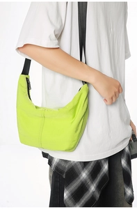 Detailed view of neon green nylon crescent bag with durable vertical stitching and zipper