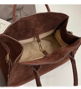 Détail du sac cabas en daim marron avec doublure beige et boucle magnétique en métal doré