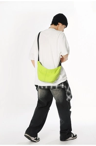 Neon green canvas crossbody bag showing natural drape and adjustable black shoulder strap
