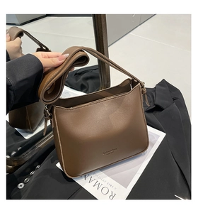 Detailed close-up of brown matte synthetic leather bucket bag with Fashion Bag lettering