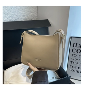 Detail of light khaki leather bucket bag with fashion bag NEW YORK embossed lettering