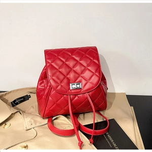 Detail shot of a red quilted leather backpack with silver twist lock and drawstring closure