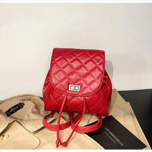 Detail of red quilted leather backpack with silver twist lock and drawstring closure