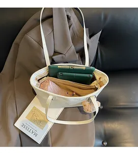 Interior view showing the large capacity of the beige tote bag with daily essentials