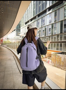 Detail of light purple nylon backpack with vertical zipper and water bottle pocket side