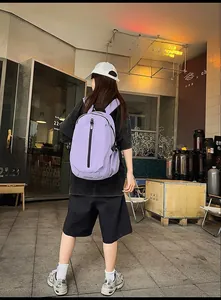 Detail view of purple oxford travel backpack showing waterproof zipper and side pockets