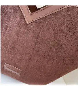 Close-up of soft brown frosted leather texture with stitched Fashion & Bags label