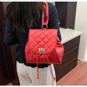 Red quilted leather backpack with silver turn-lock closure and drawstring detail