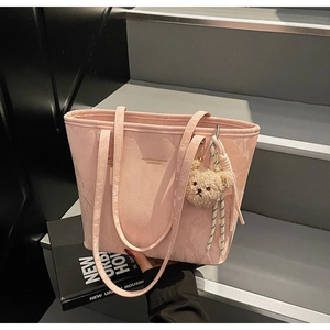 Pink glossy leather tote bag with fashion print and cute plush bear charm detail