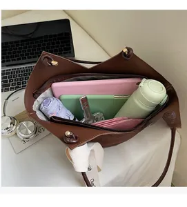 Top view of a large brown tote bag showing its spacious interior with daily essentials