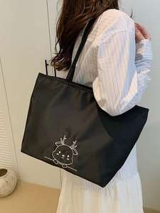 Large black nylon tote bag with cute deer embroidery shown on model for daily office use